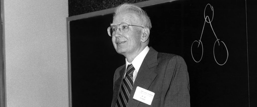 chicago-booth-ronald-coase-standing-blackboard